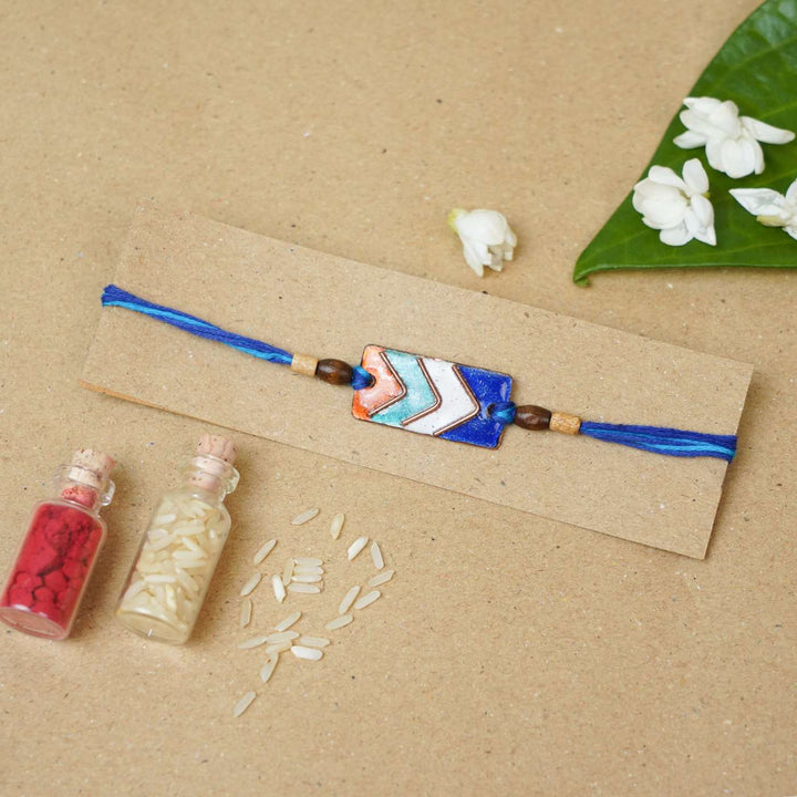 Handmade Arrows Copper Enamel Rakhi With Chocolates & Roli Chawal