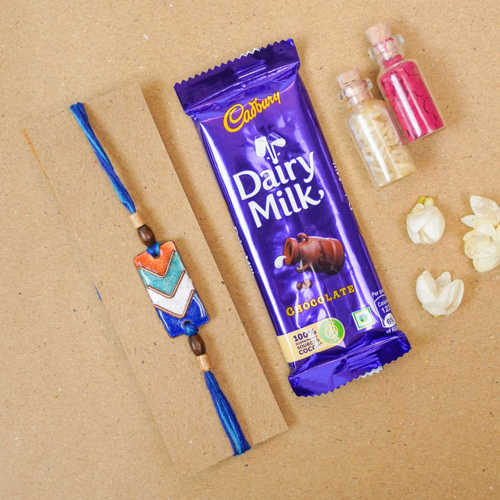Handmade Arrows Copper Enamel Rakhi With Chocolates & Roli Chawal