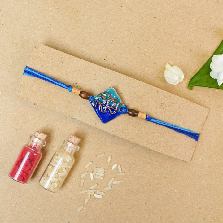 Handmade Sis Blue Copper Enamel Rakhi With Chocolates & Roli Chawal