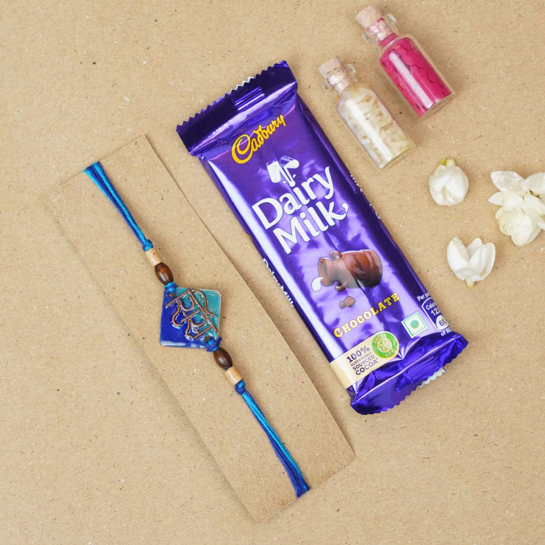Handmade Sis Blue Copper Enamel Rakhi With Chocolates & Roli Chawal