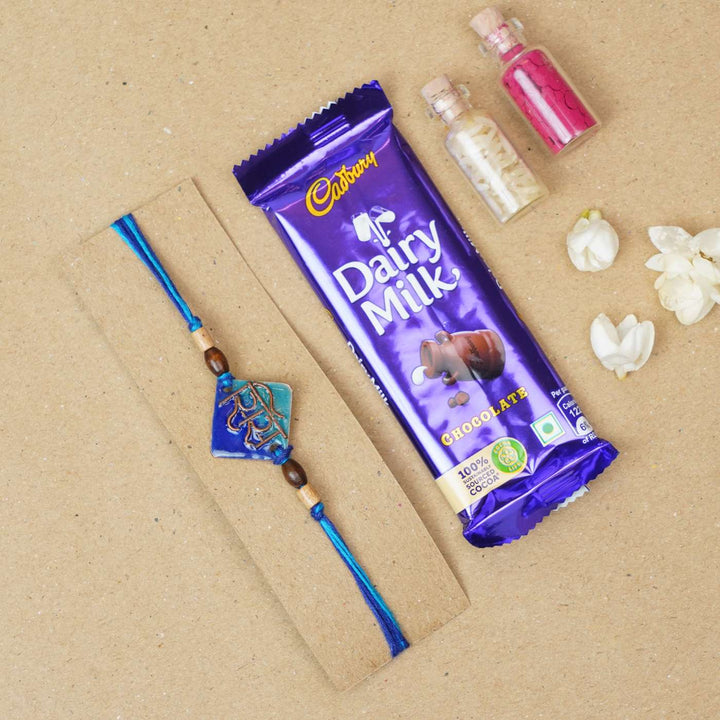 Handmade Sis Blue Copper Enamel Rakhi With Chocolates & Roli Chawal