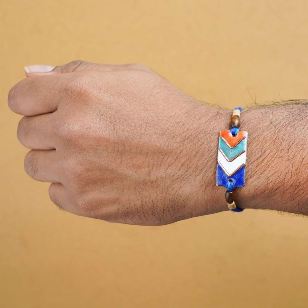 Handmade Arrows Copper Enamel Rakhi With Chocolates & Roli Chawal