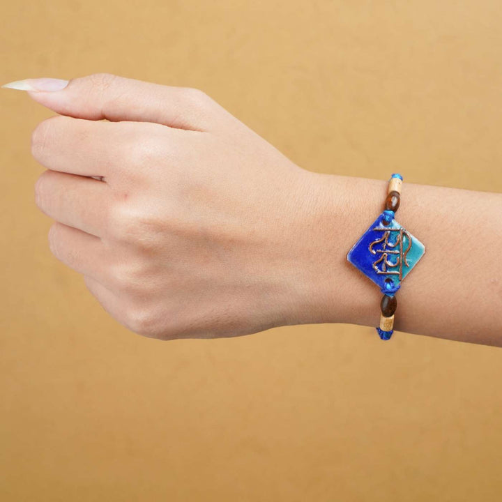 Handmade Sis Blue Copper Enamel Rakhi With Chocolates & Roli Chawal