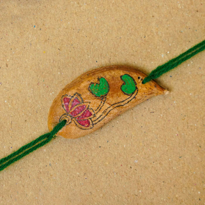 Handmade Plantable Magenta Lotus  Seed Rakhi With Roli Chawal