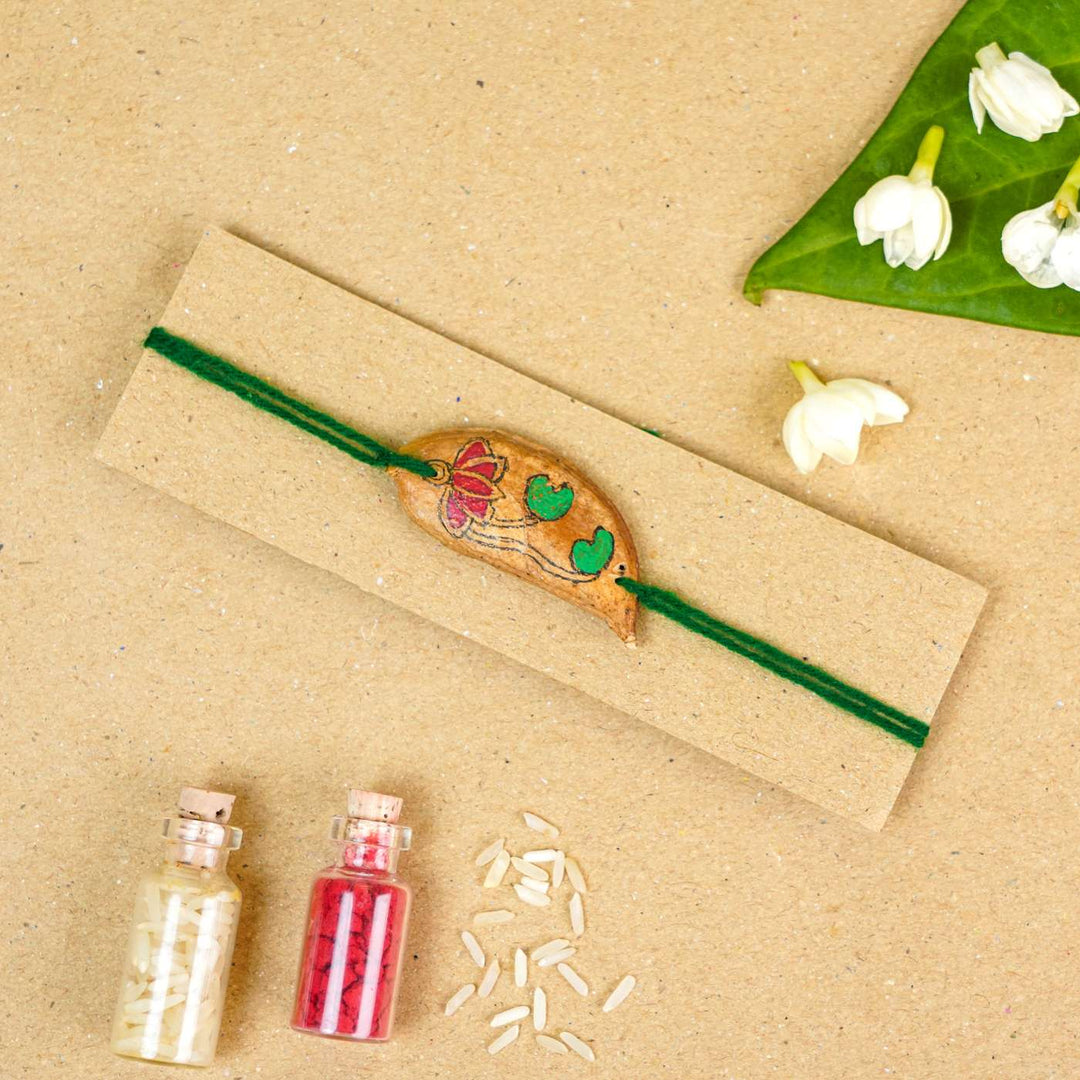 Handmade Plantable Magenta Lotus  Seed Rakhi With Roli Chawal