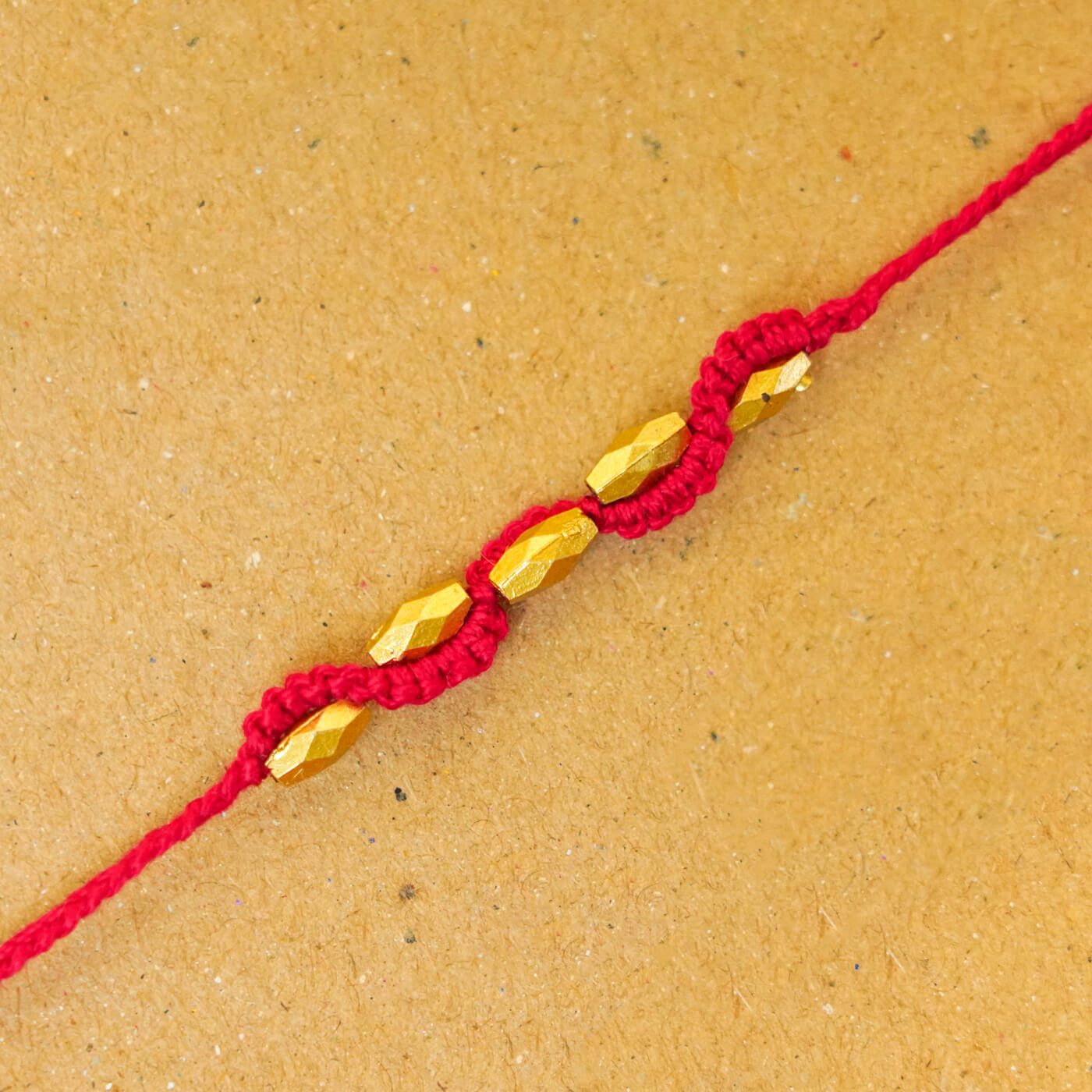 Buy Handmade Macrame Five Gold Beaded Rakhi With Roli Chawal Online On ...