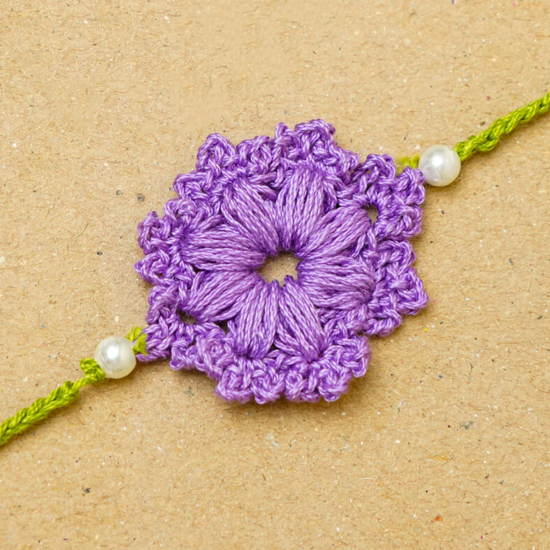Handmade Crochet Floral Cotton Rakhi With Roli Chawal - Close-up of Rakhi design