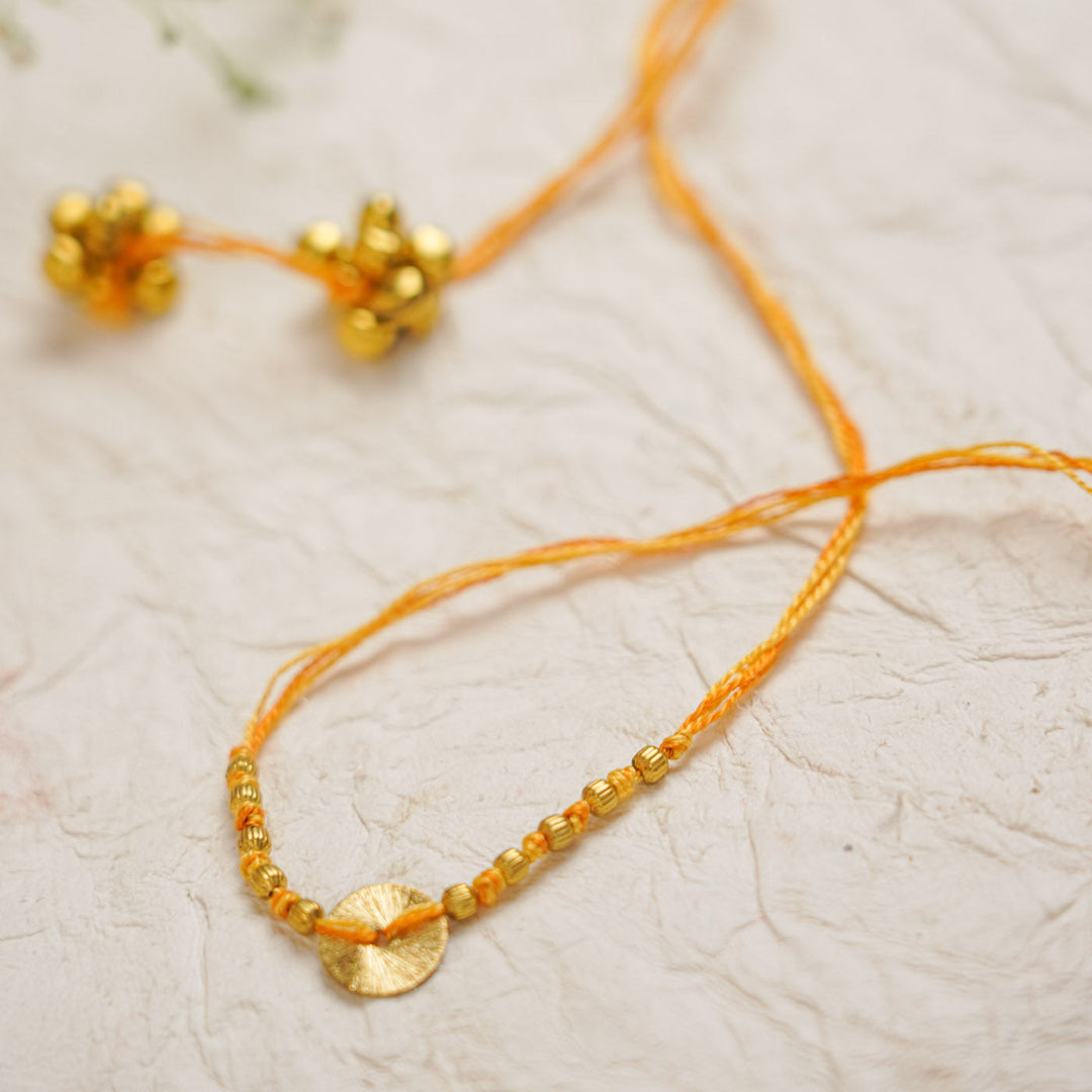 Handmade Swarn Sutra Ghungroo Bhaiya Bhabhi Rakhi With Roli Chawal - Close-up of Bell Cluster and Thread