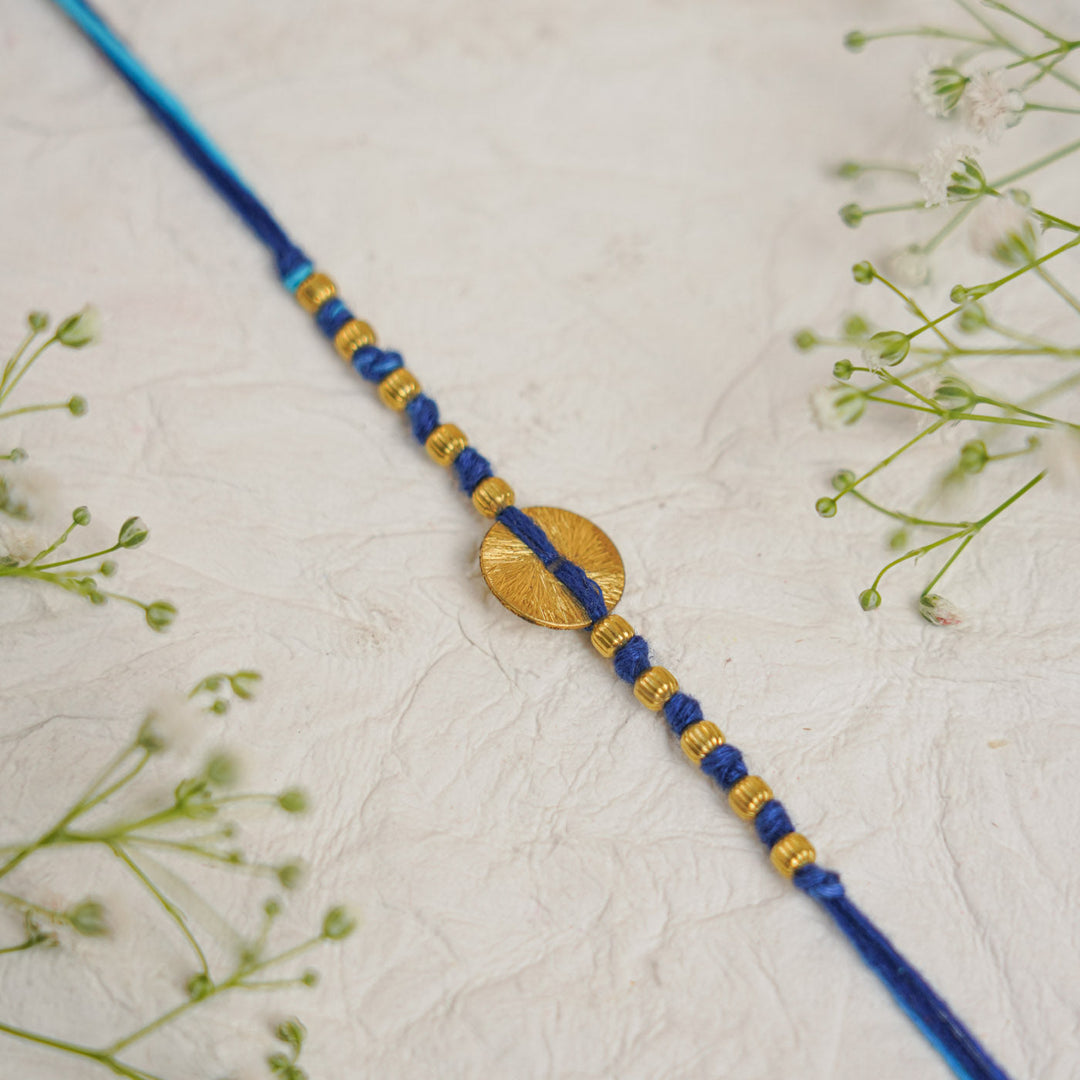Handmade Swarn Sutra Ghungroo Bhaiya Bhabhi Rakhi With Roli Chawal - Close-up of Circle Detail Blue