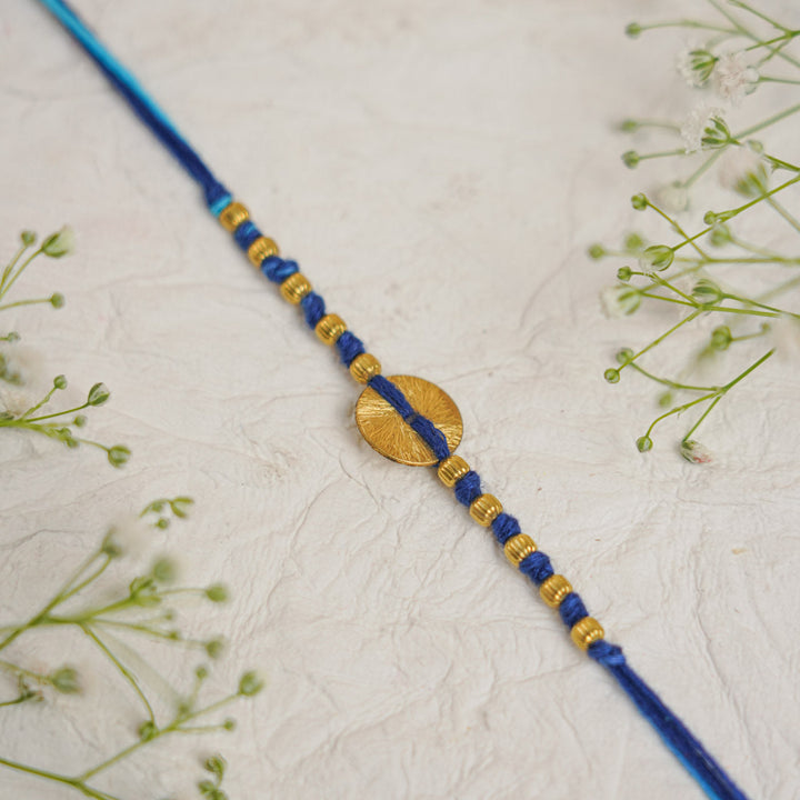 Handmade Swarn Sutra Ghungroo Bhaiya Bhabhi Rakhi With Roli Chawal - Close-up of Circle Detail Blue