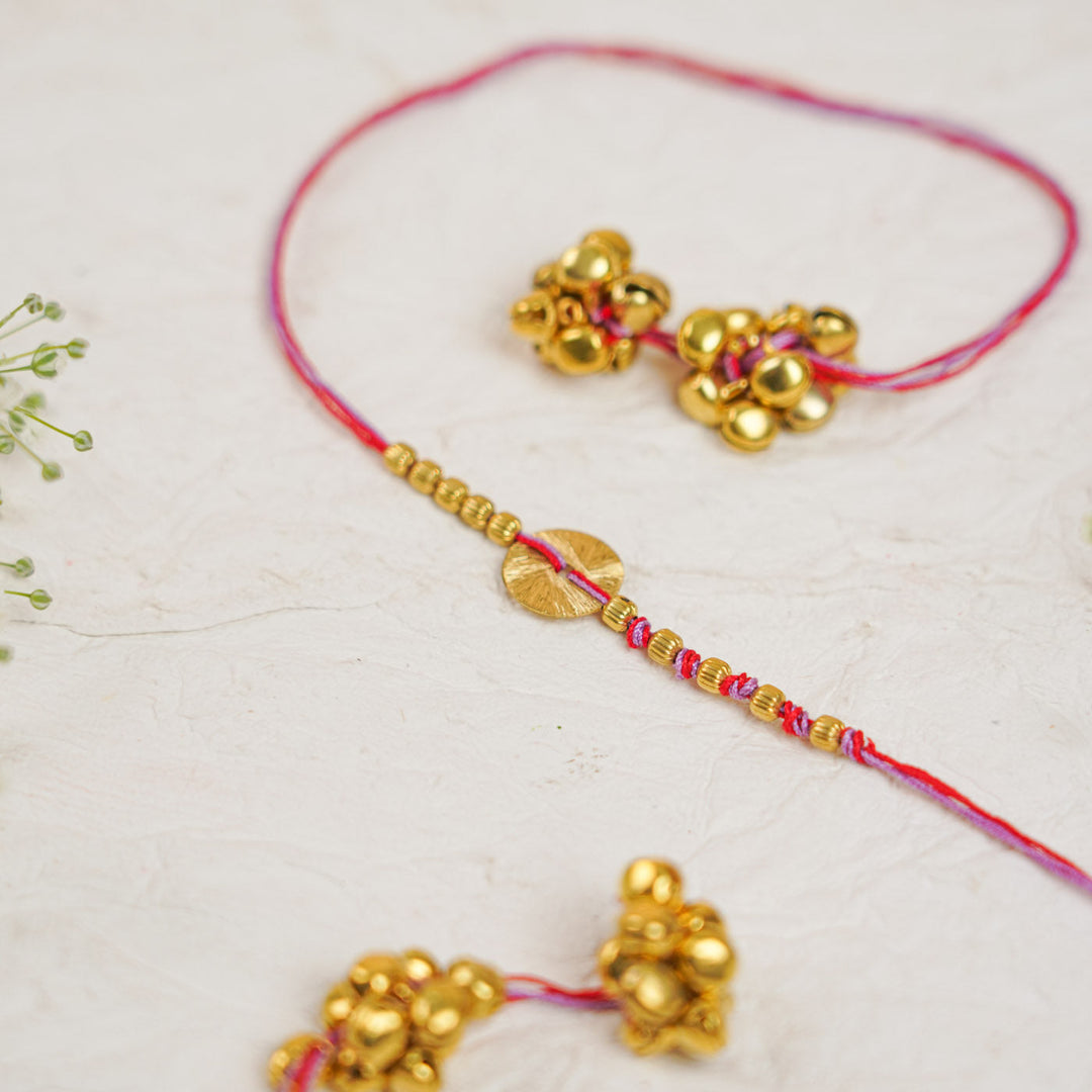 Handmade Swarn Sutra Ghungroo Bhaiya Bhabhi Rakhi With Roli Chawal - Close-up of Bell Cluster and Thread Red