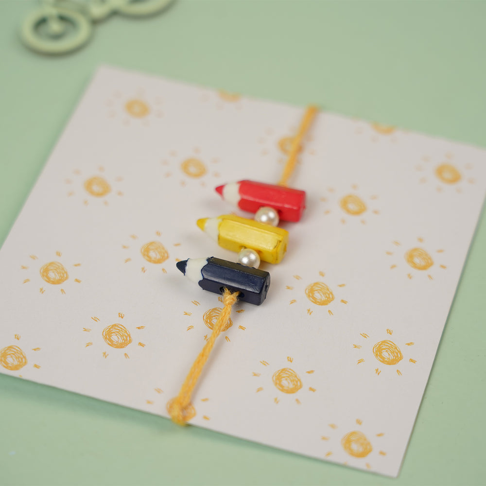 Handmade Pencil Andpearl Design Kids Rakhi With Roli Chawal - On Themed Card Display