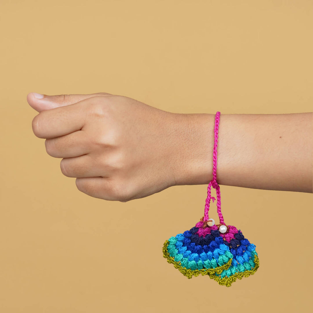 Handmade Crochet Peacock Cotton Lumba Rakhi For Bhabhi With Roli Chawal - Model wearing bracelet on wrist
