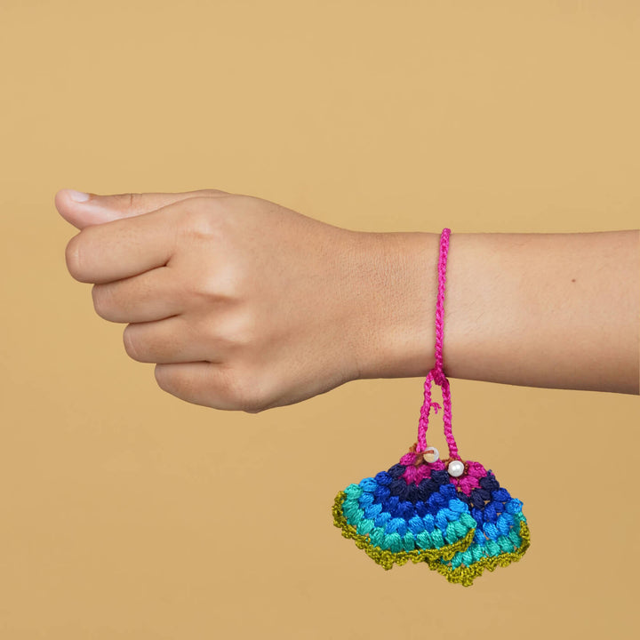 Handmade Crochet Peacock Cotton Lumba Rakhi For Bhabhi With Roli Chawal - Model wearing bracelet on wrist