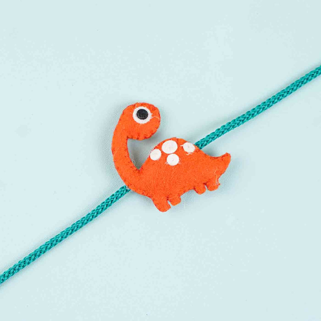 Handmade Dinosaur Felt Kids Rakhi With Roli Chawal - Close-up on Dinosaur Rakhi