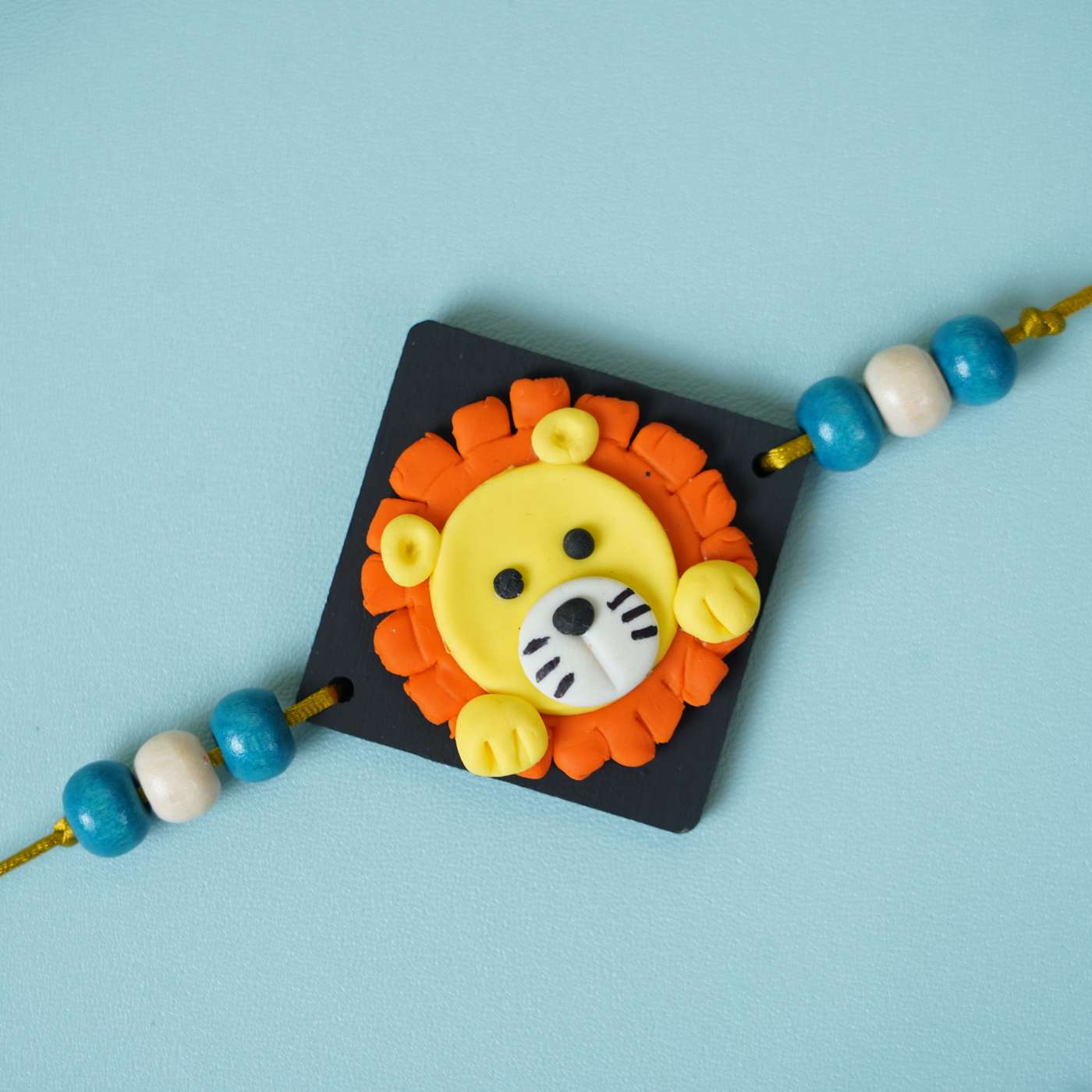 Buy Handmade Miniature Clay Lion Themed Kids Rakhi With Roli Chawal ...
