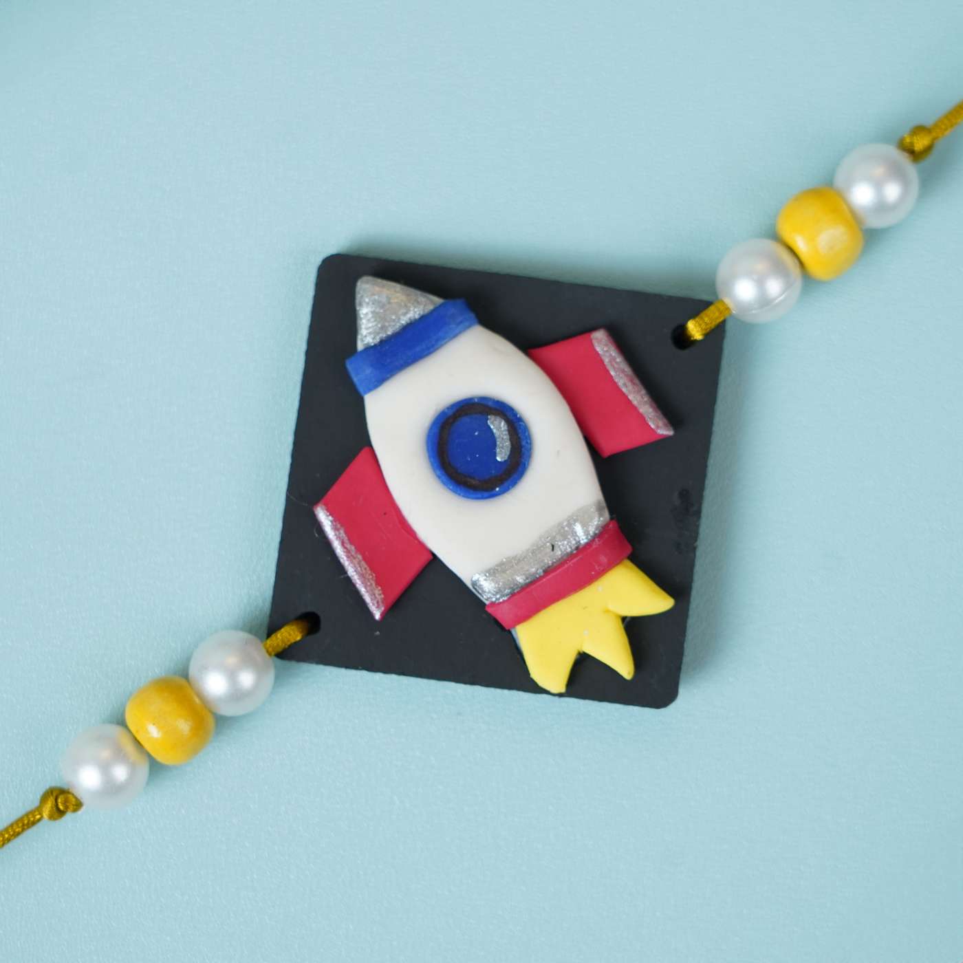 Buy Handmade Miniature Clay Space Rocket Kids Rakhi With Roli Chawal ...