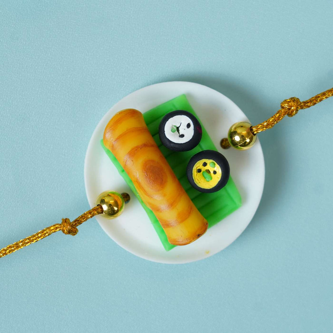 Handmade Miniature Clay Dosa Rakhi With Roli Chawal - Top Down Close-up