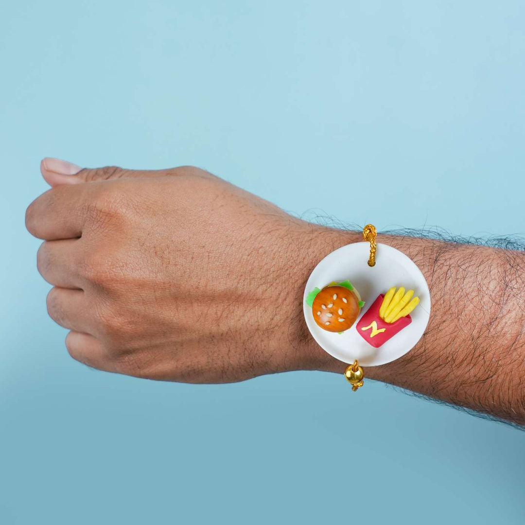 Handmade Miniature Clay Burger And Fries Rakhi With Roli Chawal - Worn on Wrist Showing Size