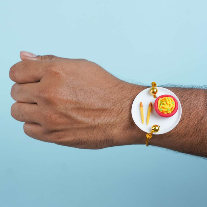 Handmade Miniature Clay Noodles Rakhi With Roli Chawal - Worn Wrist View