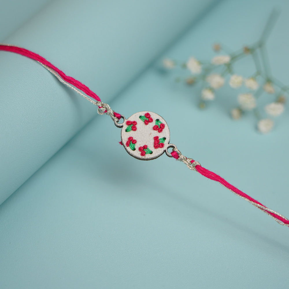 Handmade Pink Knot Design Wooden Rakhi With Roli Chawal For Brother - Styled Product Display with Props