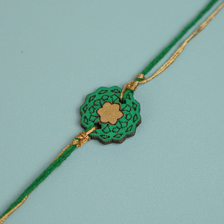 Handmade Green Flower Shape Ghungroo And Shell Wooden Bhaiya Bhabhi Rakhi With Roli Chawal - Close-up Showing String Design