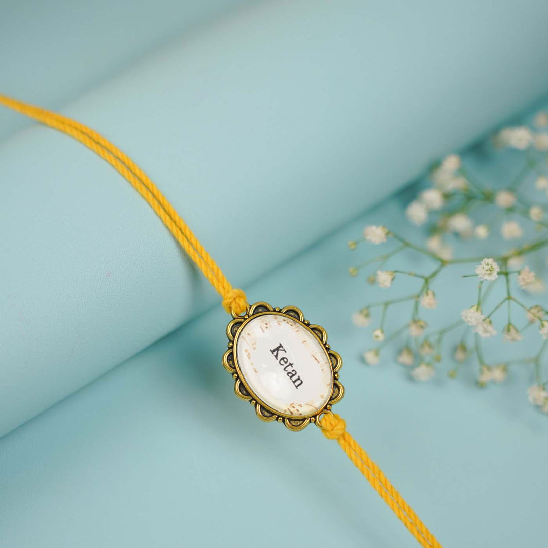 Photo Personalized Handmade Oval Antique Golden Rakhi With Roli Chawal Copy - Flat Lay Close-up