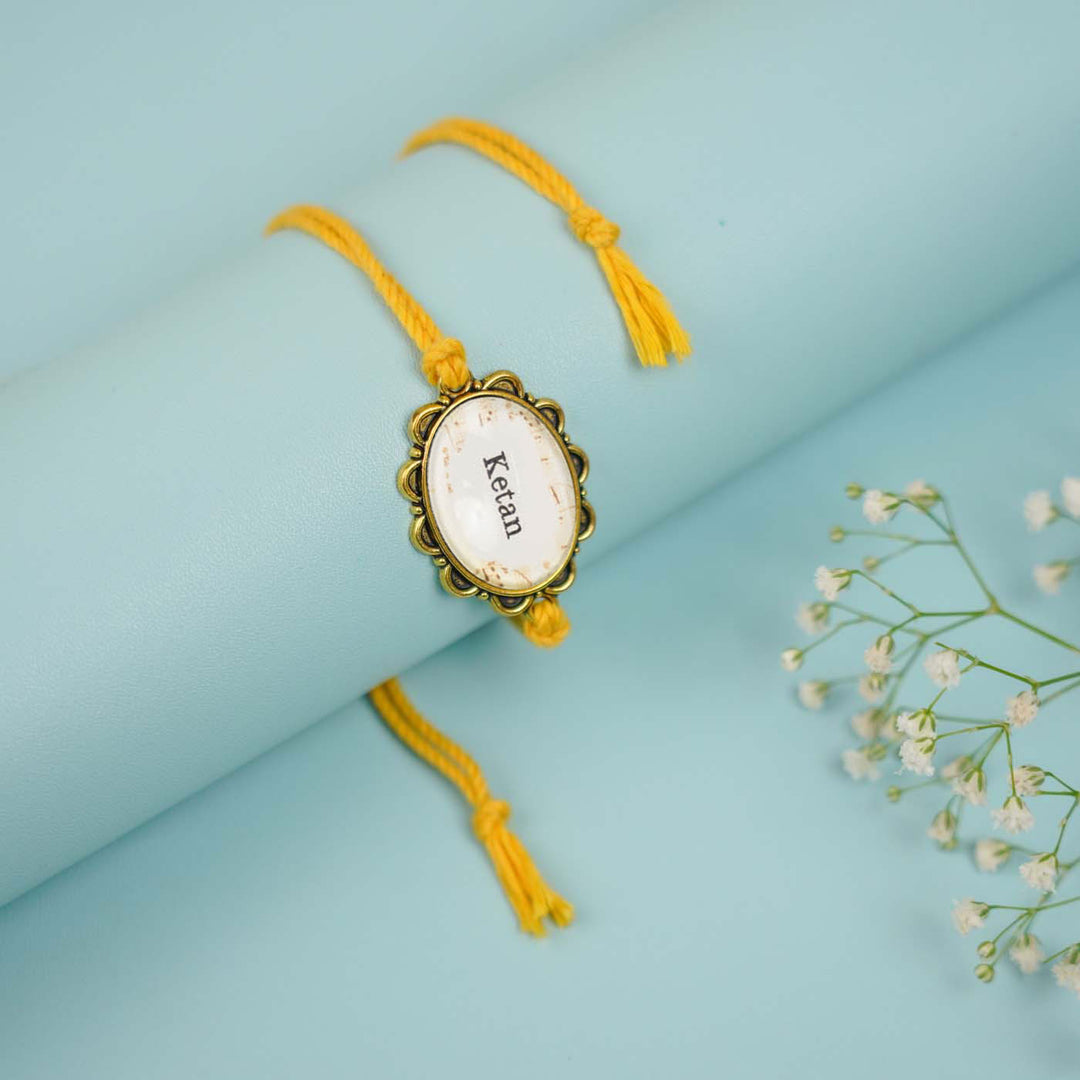 Photo Personalized Handmade Oval Antique Golden Rakhi With Roli Chawal Copy - Close-up Front View