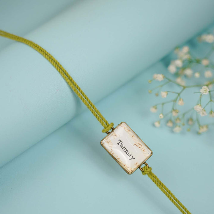 Photo Personalized Handmade Rectangle Antique Bronze Rakhi With Roli Chawal Copy - Detailed View of Name Tag