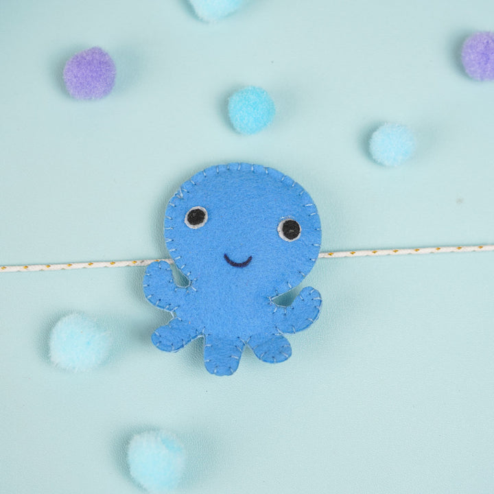 Customized Handmade Beaded Octopus Theme Felt Rakhi With Roli Chawal For Kids - Blue Octopus on String Close-up