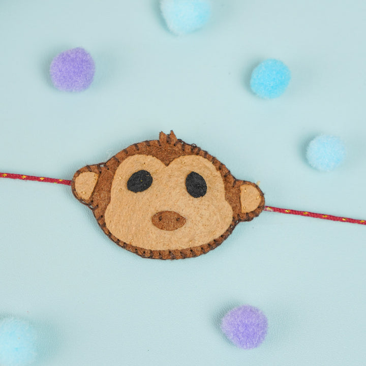Handmade Beaded Monkey Theme Pom Pom Felt Rakhi With Roli Chawal For Kids - Centered Bracelet Charm Display