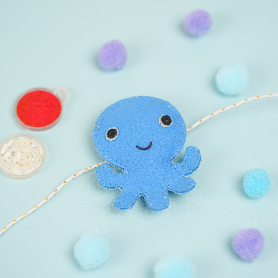Customized Handmade Beaded Octopus Theme Felt Rakhi With Roli Chawal For Kids - Blue Octopus with Paint Close-up
