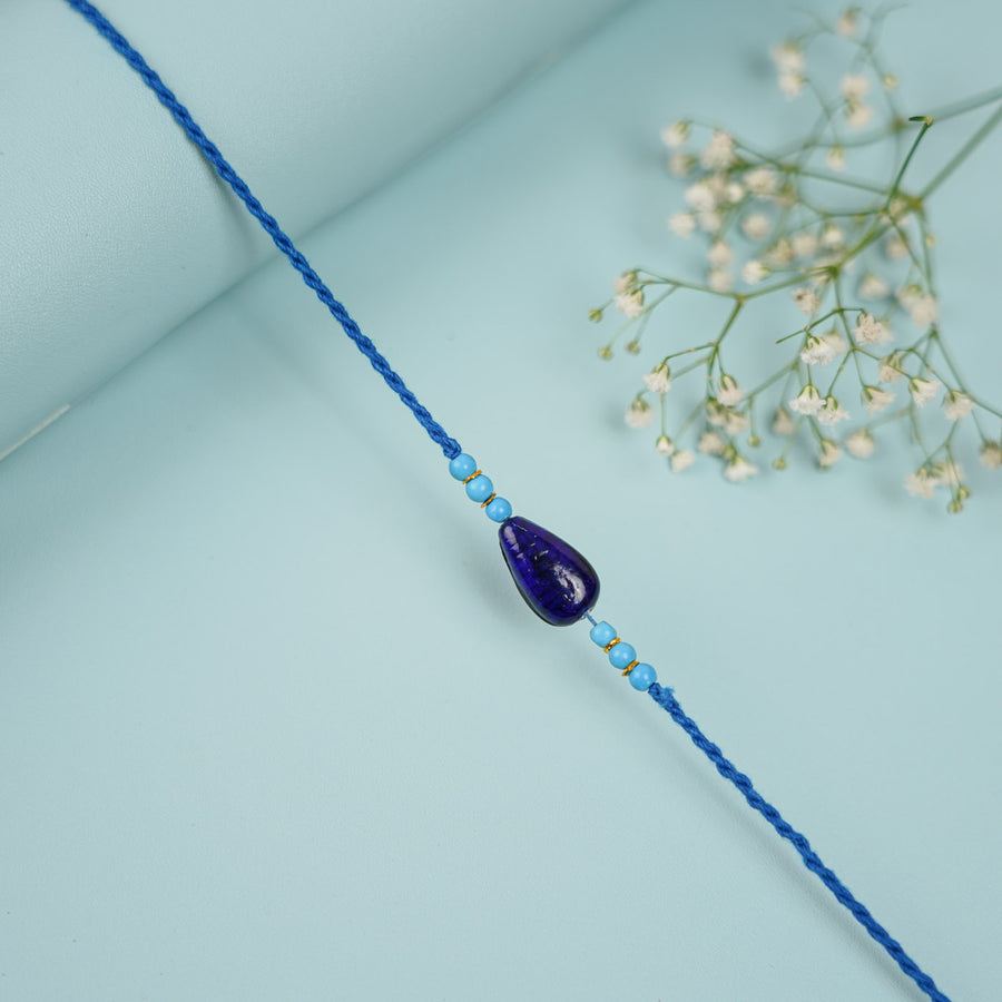 Handmade Beaded Neel Dhruv Rakhi With Roli Chawal - Close-up of Beaded Thread
