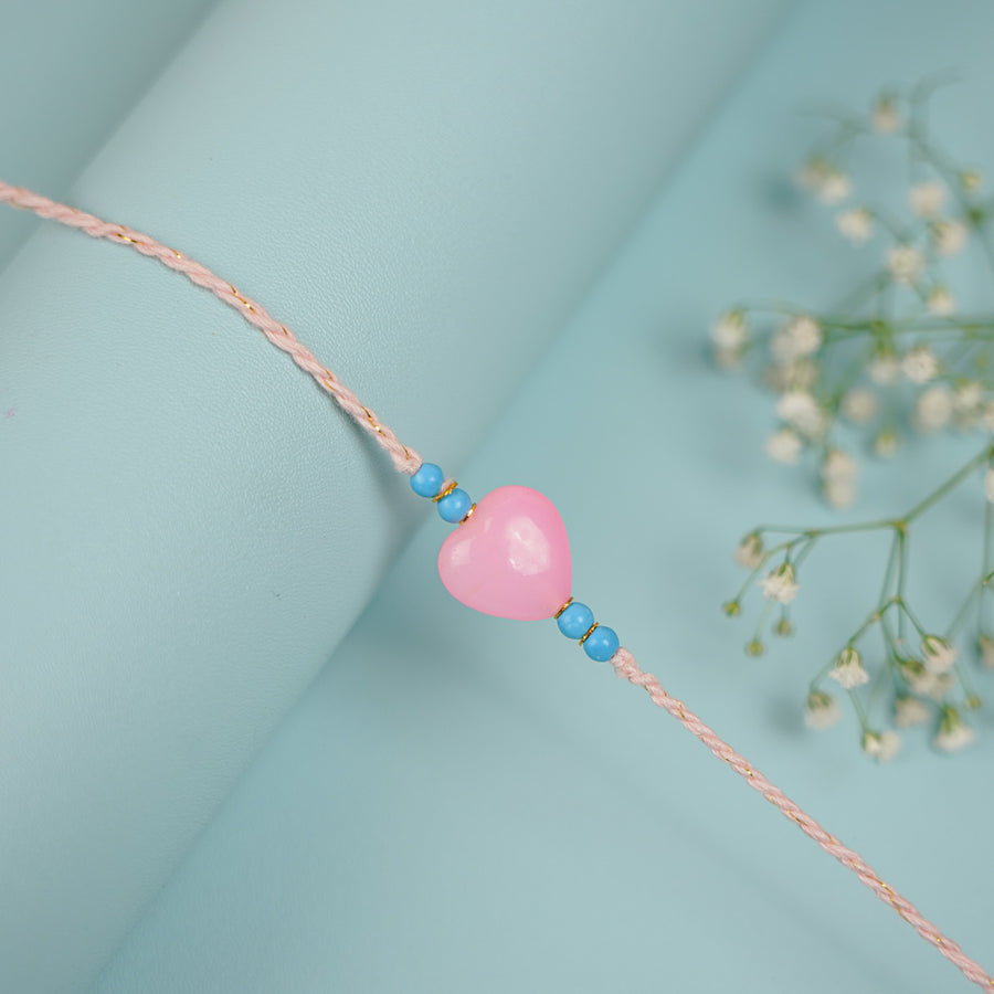 Handmade Beaded Pink Heart Dil Se Rakhi With Roli Chawal - Close-up of Heart Charm Bracelet