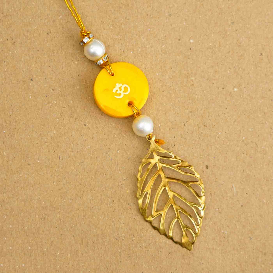 Personalized Handmade Yello Resin Lumba Rakhi For Bhabhi With Roli Chawal - Close-up of single rakhi