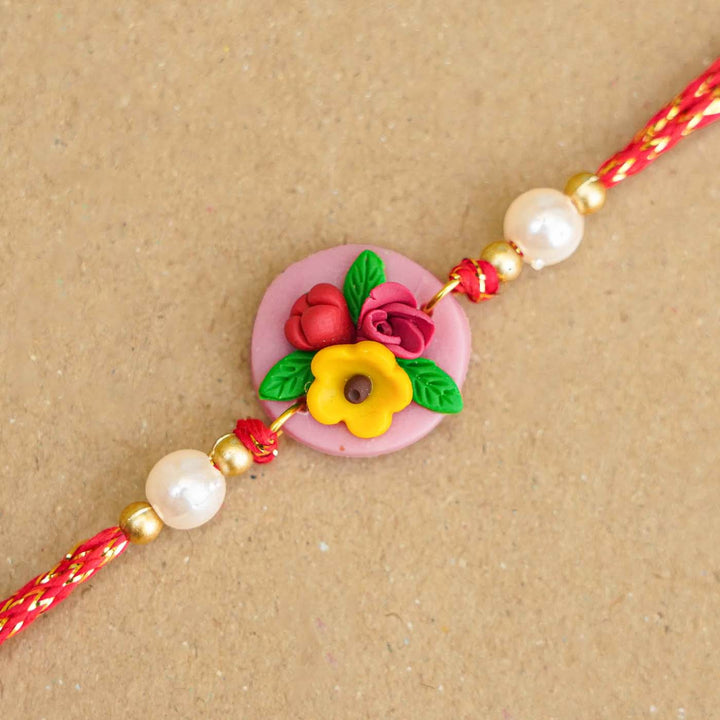 Handmade Miniature Clay Yellow and Red Floral Rakhi With Roli Chawal