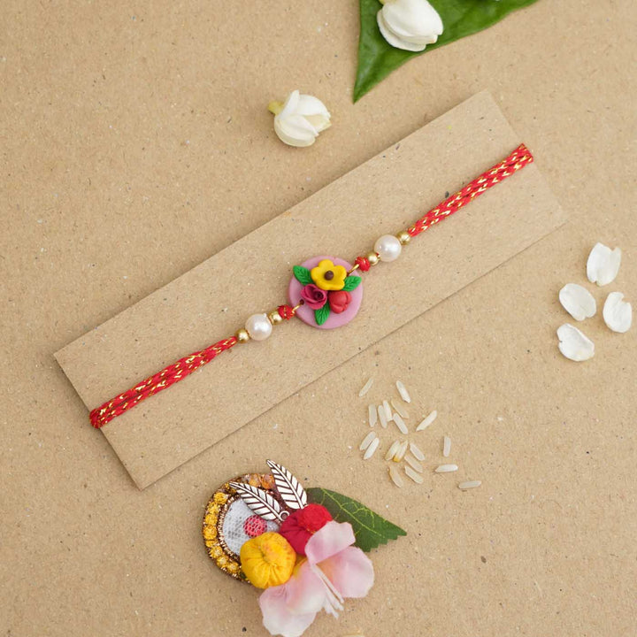 Handmade Miniature Clay Yellow and Red Floral Rakhi With Roli Chawal