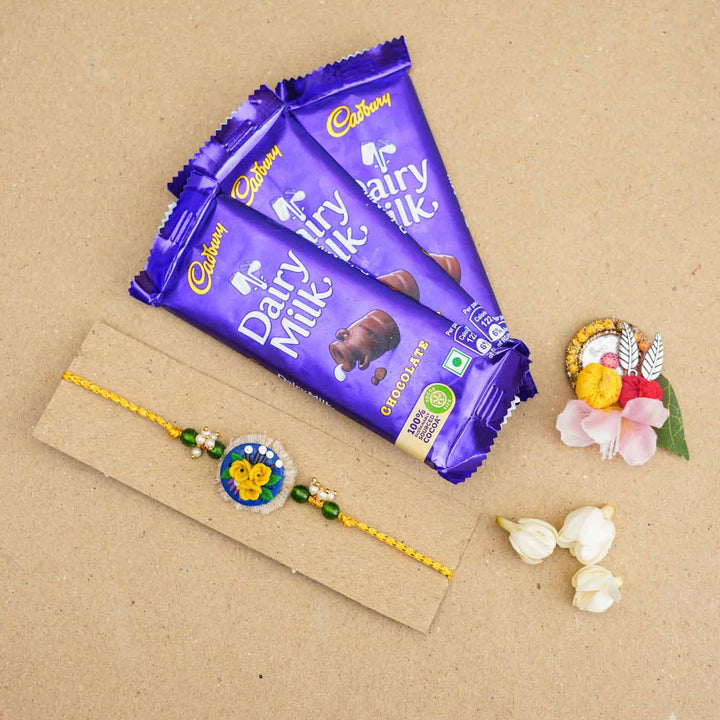 Handmade Miniature Clay Yellow and Blue Floral Rakhi With Roli Chawal