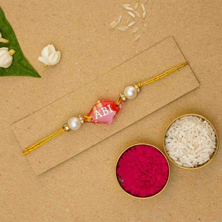 Personalized Handmade Red Resin Rakhi With Roli Chawal