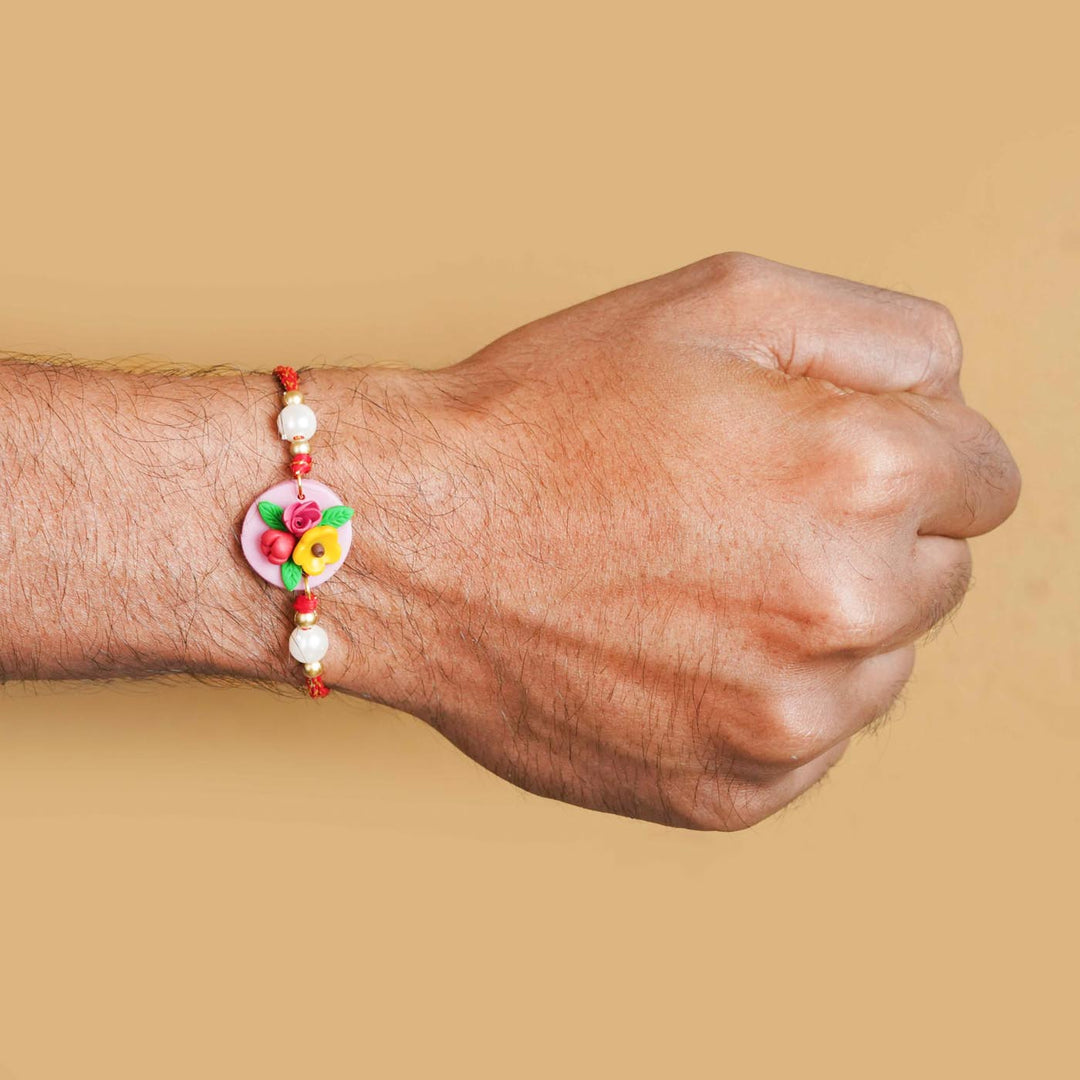 Handmade Miniature Clay Yellow and Red Floral Rakhi With Roli Chawal