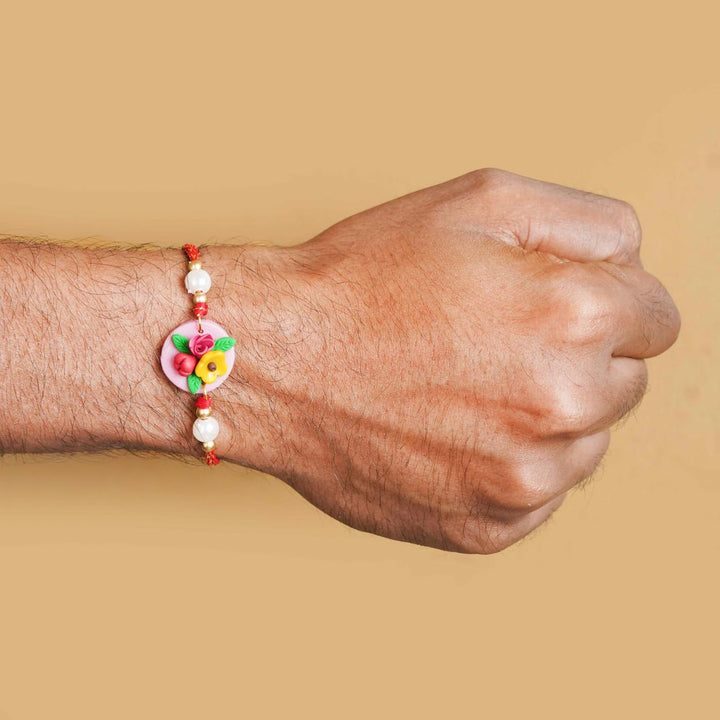 Handmade Miniature Clay Yellow and Red Floral Rakhi With Roli Chawal