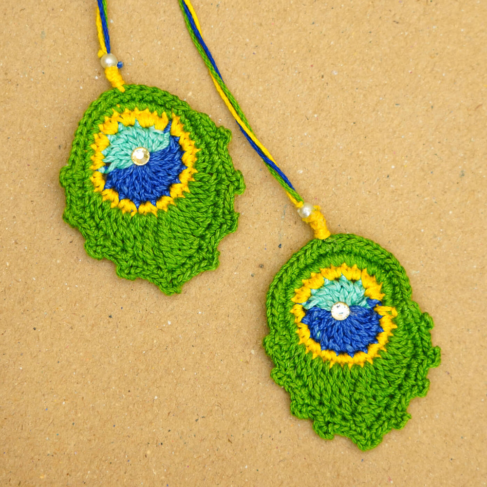 Handmade Crochet Peacock Feather Cotton Lumba Rakhi For Bhabhi With Roli Chawal - Close-up Front View