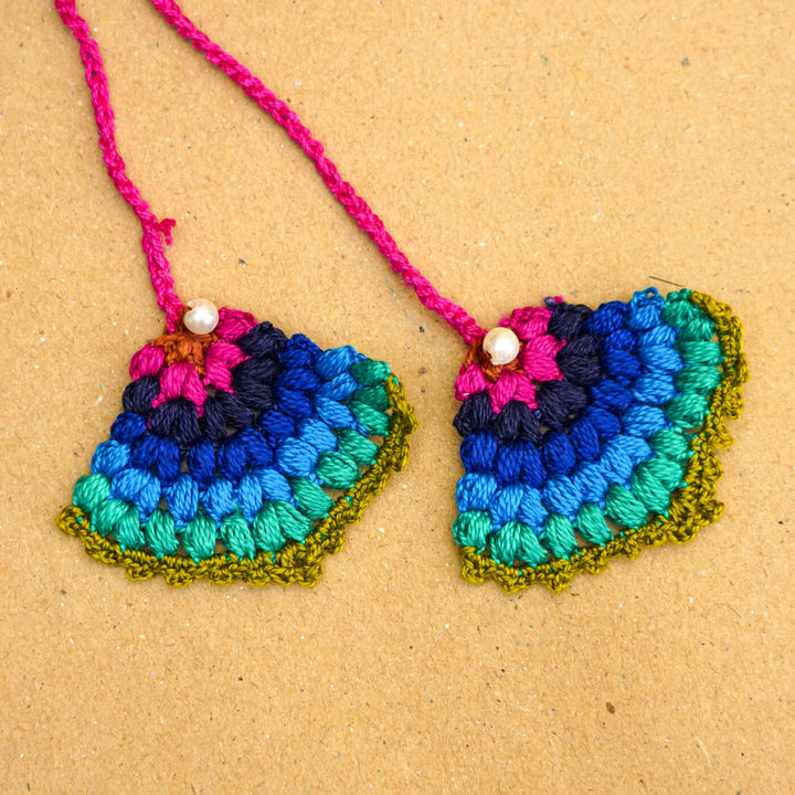 Handmade Crochet Peacock Cotton Lumba Rakhi For Bhabhi With Roli Chawal - Close-up of crochet earrings