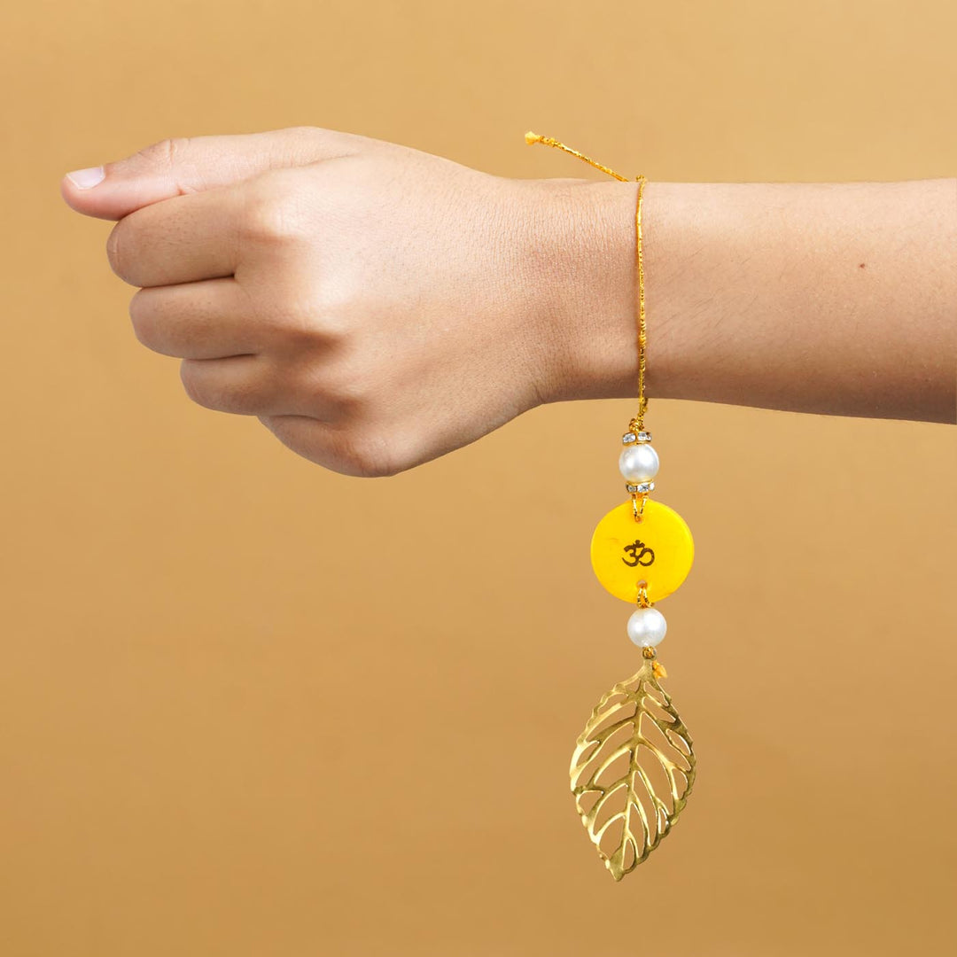 Personalized Handmade Yello Resin Lumba Rakhi For Bhabhi With Roli Chawal - Model wrist showing rakhi wear