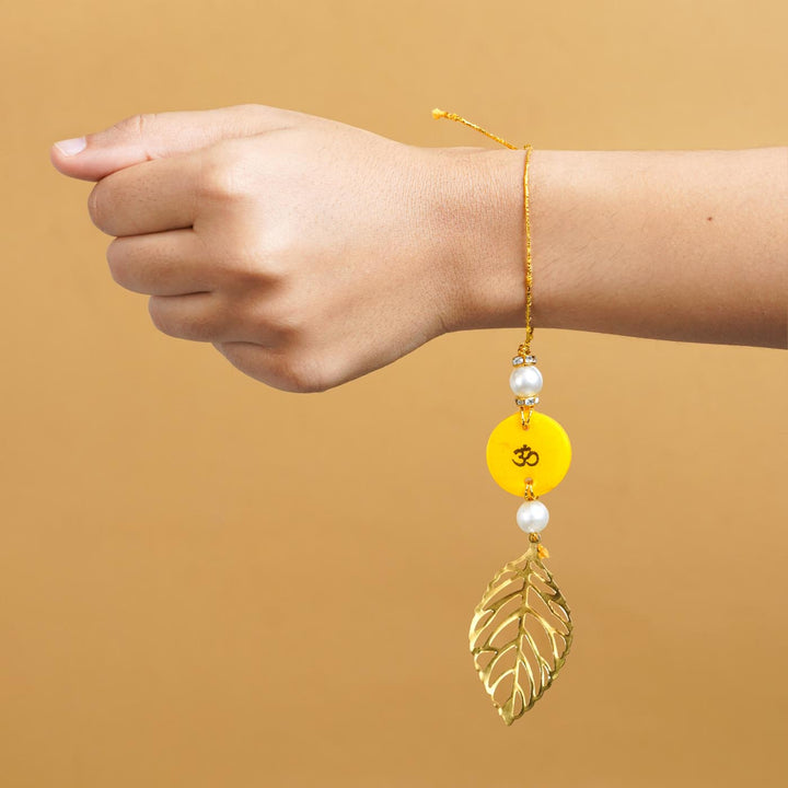 Personalized Handmade Yello Resin Lumba Rakhi For Bhabhi With Roli Chawal - Model wrist showing rakhi wear
