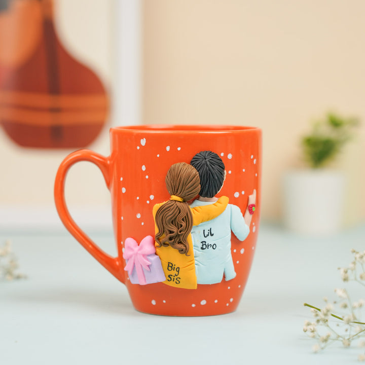 Handmade Big Sis And Lil Bro Clay Rakhi Hamper With Roli Chawal Includes 1 Mug 1 Rakhi - Mug Front View Isolated