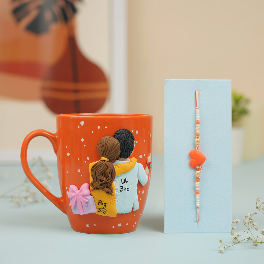 Handmade Big Sis And Lil Bro Clay Rakhi Hamper With Roli Chawal Includes 1 Mug 1 Rakhi - Mug with Rakhi Set Front View