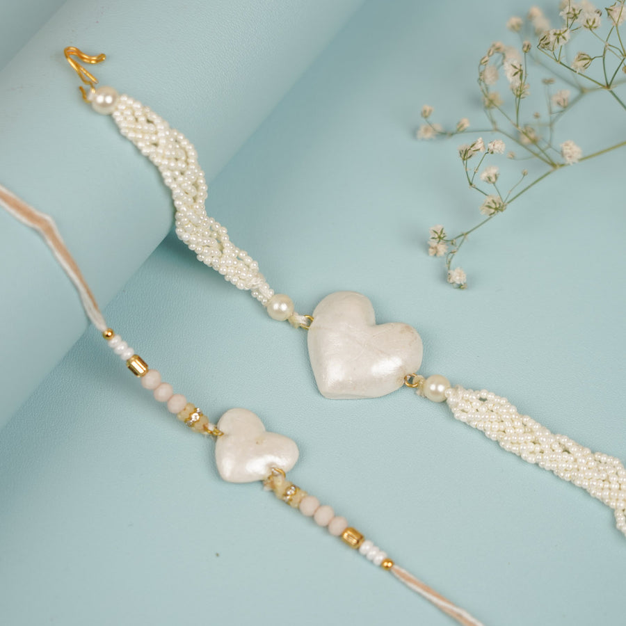 Handmade Heart Shaped Moti Clay Bhaiya Bhabhi Rakhi With Roli Chawal Set Of 2 - Two Bracelets Laid Flat