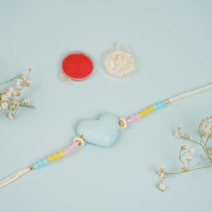 Handmade Heart Shaped Clay Bhaiya Bhabhi Rakhi With Roli Chawal Set Of 2 - Close-up of Blue Heart Bracelet