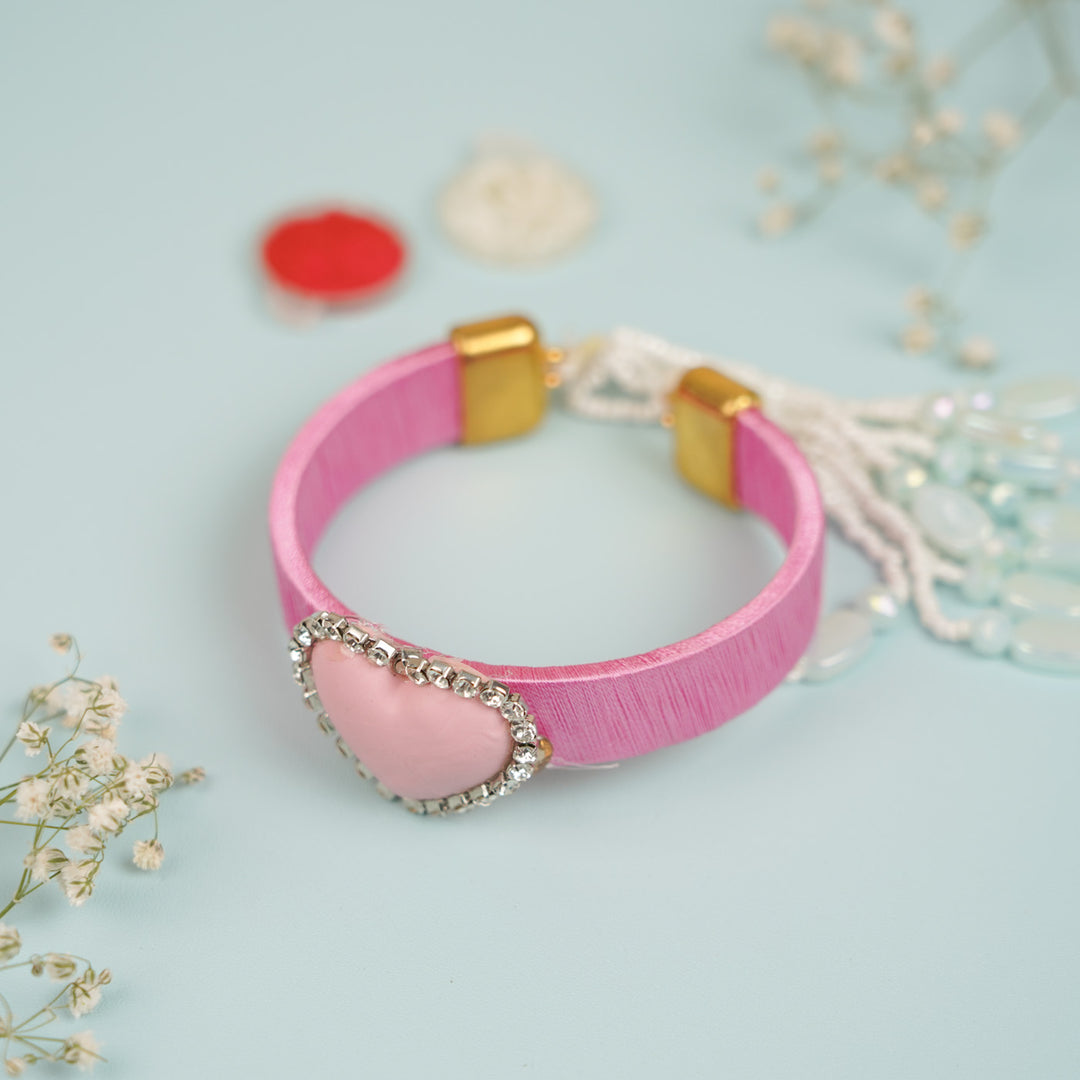 Handmade Heart Shaped Clay Bhaiya Bhabhi Rakhi With Roli Chawal Set Of 2 - Bracelets with Accessories Displayed